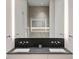Modern bathroom featuring double sinks, sleek fixtures, and a frameless glass shower for a clean and contemporary look at 1051 Wimberly Ne Rd, Brookhaven, GA 30319