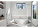 Elegant bathroom with a modern soaking tub, glass shower, and stylish shelving at 1051 Wimberly Ne Rd, Brookhaven, GA 30319