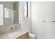 A bright bathroom with a modern sink, toilet, and walk-in shower accented with light fixtures at 1051 Wimberly Ne Rd, Brookhaven, GA 30319