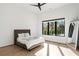 Bright, minimalist bedroom with large window, hardwood floors, and modern ceiling fan at 1051 Wimberly Ne Rd, Brookhaven, GA 30319