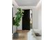 Elegant entryway with hardwood floors, sleek black door, and stylish plant at 1051 Wimberly Ne Rd, Brookhaven, GA 30319