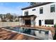 Modern home exterior with a pool, wood deck, and sleek architectural design at 1051 Wimberly Ne Rd, Brookhaven, GA 30319
