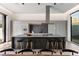 Sleek modern kitchen with waterfall island, stainless steel appliances, and bar stool seating at 1051 Wimberly Ne Rd, Brookhaven, GA 30319