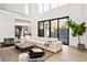 Bright living room boasting high ceilings, floor-to-ceiling sliding doors, and stylish modern furniture at 1051 Wimberly Ne Rd, Brookhaven, GA 30319