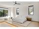 Bright main bedroom with large windows, ceiling fan, minimalist furniture and hardwood floors on a split level platform at 1051 Wimberly Ne Rd, Brookhaven, GA 30319
