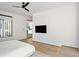 Minimalist main bedroom with a wall-mounted TV, hardwood floors and a partial view to a modern bathroom at 1051 Wimberly Ne Rd, Brookhaven, GA 30319