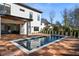 Backyard with a modern rectangular pool, wood deck, and manicured landscaping at 1051 Wimberly Ne Rd, Brookhaven, GA 30319