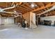 Unfinished basement with open ceiling and concrete floors at 1300 Valley Ct, Roswell, GA 30075