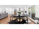 Stylish dining area with modern table and chairs, flowing into a bright, updated kitchen at 1300 Valley Ct, Roswell, GA 30075