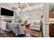 Comfortable living room showcasing the coffered ceiling, fireplace, and an open layout at 1358 Magnolia Path Way, Sugar Hill, GA 30518