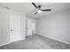 Bedroom featuring grey carpet, ceiling fan, and entrance to hallway at 2199 Blue Creek Ct, Conley, GA 30288