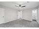 Carpeted bedroom featuring ceiling fan and entrance to the attached bathroom at 2199 Blue Creek Ct, Conley, GA 30288