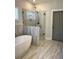 Luxurious bathroom featuring a soaking tub and walk-in shower with glass surround at 224 Crest Creek Way, Villa Rica, GA 30180