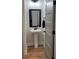 Bathroom with gray paneled door, white toilet and sink at 224 Crest Creek Way, Villa Rica, GA 30180