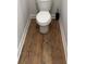 Bathroom with dark brown wooden floors and white toilet at 224 Crest Creek Way, Villa Rica, GA 30180
