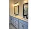 Bathroom vanity with double sinks, white countertop, and gray cabinets at 224 Crest Creek Way, Villa Rica, GA 30180