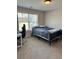 Well-lit bedroom featuring a comfortable bed, chair, and large window at 224 Crest Creek Way, Villa Rica, GA 30180