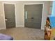 View of neutral toned bedroom with closet doors and plush carpet flooring at 224 Crest Creek Way, Villa Rica, GA 30180