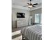 This bedroom has a dresser, mirror, and a ceiling fan at 224 Crest Creek Way, Villa Rica, GA 30180