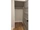 Empty closet featuring wood flooring, white trim, and single wire rack at 224 Crest Creek Way, Villa Rica, GA 30180