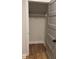 Empty closet with gray paneled door and wooden floor at 224 Crest Creek Way, Villa Rica, GA 30180