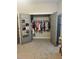 Walk-in closet with hanging clothes and shoe organizer at 224 Crest Creek Way, Villa Rica, GA 30180