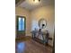 Welcoming entryway with hardwood floors, console table, and stylish round mirror at 224 Crest Creek Way, Villa Rica, GA 30180