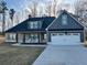 Charming single-Gathering home featuring a modern design with board and batten siding and a well-manicured lawn at 224 Crest Creek Way, Villa Rica, GA 30180