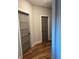 Hallway with hardwood floors and neutral paint, leading to bedroom doors at 224 Crest Creek Way, Villa Rica, GA 30180