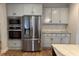 Bright kitchen featuring stainless steel appliances and white cabinets at 224 Crest Creek Way, Villa Rica, GA 30180
