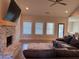 Bright living room with a brick fireplace, neutral color palette, and three windows, offering a cozy and inviting atmosphere at 224 Crest Creek Way, Villa Rica, GA 30180