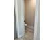 Small powder room featuring a toilet, neutral paint and tiled floors at 224 Crest Creek Way, Villa Rica, GA 30180
