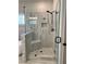 Spa-like shower with glass enclosure, seat, rainfall showerhead, and tiled surround at 224 Crest Creek Way, Villa Rica, GA 30180