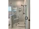 Luxurious walk-in shower with glass surround, seat, and gray tile at 224 Crest Creek Way, Villa Rica, GA 30180