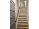 Staircase with wooden handrail, white risers and wooden treads at 224 Crest Creek Way, Villa Rica, GA 30180