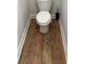 Small toilet room with wood flooring and white trim at 224 Crest Creek Way, Villa Rica, GA 30180