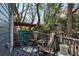 Cozy back deck with rocking chairs, a rug, and view of the serene, green backyard at 109 Chester Se Ave, Atlanta, GA 30316