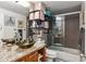 Stylish bathroom featuring a unique glass vessel sink, granite countertop, and sleek sliding glass shower doors at 109 Chester Se Ave, Atlanta, GA 30316