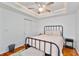 Comfortable bedroom featuring a tray ceiling, fan and natural light, creating a warm atmosphere at 109 Chester Se Ave, Atlanta, GA 30316