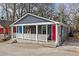 Charming home featuring a covered front porch, a red front door, and stylish curb appeal at 109 Chester Se Ave, Atlanta, GA 30316