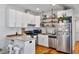 Contemporary kitchen featuring white cabinetry, stainless steel appliances, and a stylish breakfast bar at 109 Chester Se Ave, Atlanta, GA 30316