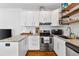 Modern kitchen featuring stainless steel appliances, granite countertops, and stylish white cabinetry at 109 Chester Se Ave, Atlanta, GA 30316