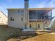 Back exterior showcases a screened-in porch, a patio, and a spacious backyard at 1182 Tupelo Chase Ct, Auburn, GA 30011