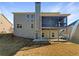 Backyard view of home featuring a screened porch, open deck and walkout basement at 1182 Tupelo Chase Ct, Auburn, GA 30011