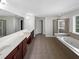Large bathroom with double sinks, a jetted tub, and a separate shower at 1182 Tupelo Chase Ct, Auburn, GA 30011