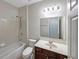 This bathroom features a bathtub with shower, single sink vanity, and a large mirror at 1182 Tupelo Chase Ct, Auburn, GA 30011