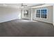 Large bedroom featuring carpet floors, a ceiling fan and tray ceiling at 1182 Tupelo Chase Ct, Auburn, GA 30011