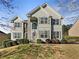 Charming two-story home featuring a meticulously landscaped front yard and stone accents at 1182 Tupelo Chase Ct, Auburn, GA 30011