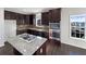 Modern kitchen with stainless steel appliances, granite countertops, and a center island at 1182 Tupelo Chase Ct, Auburn, GA 30011