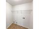 A functional laundry room with tile floors and a wire storage shelf at 1182 Tupelo Chase Ct, Auburn, GA 30011